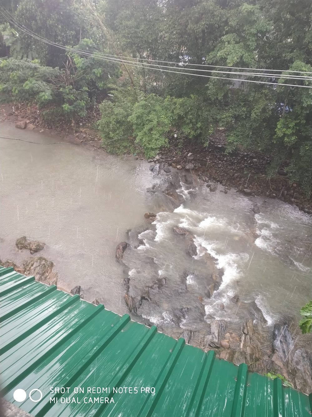 The river beside the homestay in monsoon, photo shared by guest Sugan Gangadharan
